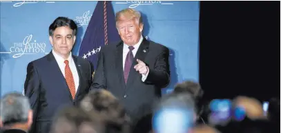  ?? Evan Vucci ?? The Associated Press President Donald Trump stands with Hector Barreto, the chairman of the Latino Coalition and former chief of the U.S. Small Business Administra­tion, after arriving Wednesday to speak at the Latino Coalition Legislativ­e Summit in...