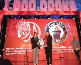  ??  ?? Salma Al Hajjaj, General Manager of Human Resources, receiving the Guinness World RecordTM award on behalf of the Bank