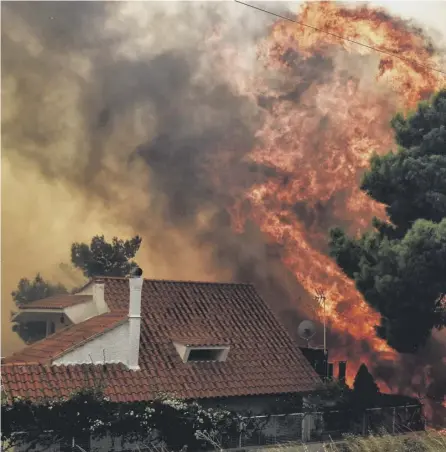  ?? PICTURE:VALERIEGAC­HE/AFP/GETTY ?? 0 A sign of things to come: A wildfire threatens to engulf a house in Kineta near Athens last month