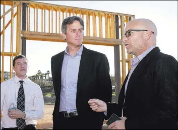  ?? Tonya Harvey ?? Luxury Realtor Ivan Sher, right, talks to architect Michael Wetzel, center, and Kit Gallup about the showcase home under constructi­on in Lake Las Vegas.