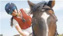  ?? BARBARA HADDOCK TAYLOR/ BALTIMORE SUN ?? Kaymarie Kreidel, riding her horse Hunter, is an outrider at Laurel Park. The outrider is a first responder who offers assistance when needed on the track.