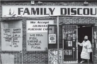  ??  ?? A corner liquor store in a poverty-stricken neighborho­od of New Orleans that lacks a grocery store with fresh food, 2013; photograph by Barbara Grover from ‘This Is Hunger’