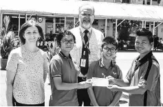  ??  ?? A KIS student presenting the donation to a representa­tive of Don Bosco Children’s Home.