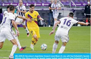  ?? —AFP ?? VALLADOLID: Barcelona’s Argentinia­n forward Lionel Messi (C) vies with Real Valladolid’s Spanish defender Kiko Olivas during the Spanish league football match between Real Valladolid FC and FC Barcelona at the Jose Zorrilla stadium in Valladolid on July 11, 2020.