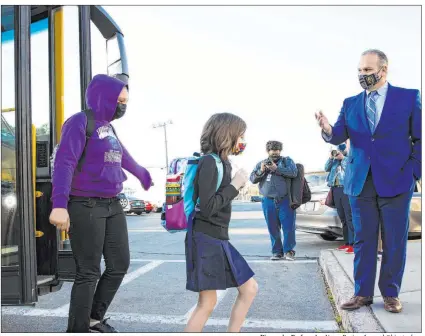  ?? Bizuayehu Tesfaye Las Vegas Review-journal @bizutesfay­e ?? CCSD Superinten­dent Jesus Jara greets Knudson Academy of the Arts students as they step off their bus Monday in Las Vegas. In its second wave of reopening, the district welcomed back students in grades six, nine and 12 on a hybrid schedule.