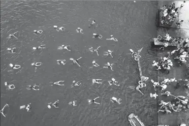  ?? LI FUHUA / FOR CHINA DAILY ?? People swim across the Hanjiang River in Xiangyang, Hubei province, to commemorat­e Chairman Mao Zedong’s crossing of the Yangtze River four times between 1956 and 1966.