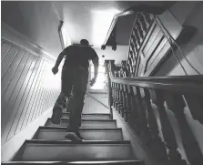  ??  ?? Matt Zhao of UCRez Property Management makes his way up a staircase inside the old Sandwich post office on Wednesday.