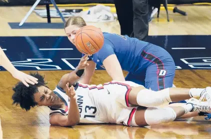  ?? DAVID BUTLER II / AP ?? Connecticu­t guard Christyn Williams (13) battles for the ball against DePaul during the second half Tuesday night in Storrs, Conn.