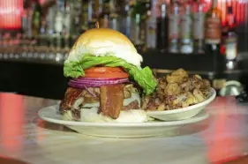  ?? For the Post-Gazette ?? The tavern-style Gourmet Kelly Burger at Tessaro's is served with home fries and piled high.