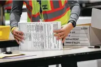  ?? Spencer Platt / Tribune News Service file photo ?? An election worker in Philadelph­ia prepares ballots for counting in this photo from Nov. 4.