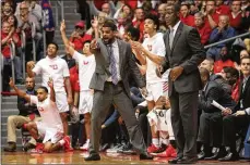  ?? DAVID JABLONSKI PHOTOS / STAFF ?? Dayton’s bench, including coaches Ricardo Greer (center) and Anthony Grant react after a score Sunday against UMass at UD Arena.