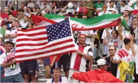  ?? Photograph: Patrick Kovarik/AFP/Getty Images ?? Iran and USA fans mingle at the Stade de Gerland in Lyon during a match that took place against the backdrop of a US trade embargo.