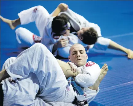  ?? ALLEN MCINNIS ?? Athletes train in Brazilian jiu-jitsu at the Gracie Barra Montreal martial arts school. Some in Montreal’s martial arts community are blaming a “malicious” battle between local promoters for the recent police decision to ban a jiu-jitsu tournament from...