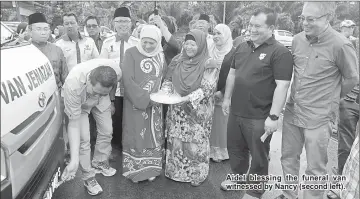  ??  ?? Aidel blessing the funeral van witnessed by Nancy (second left).