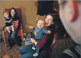  ?? Rick Loomis For The Times ?? ANNIE, left, with mom Christine Scarfuto, and Sean, with mom Liz Hayes, are two of several infants who share the role of Bobby Carney in “The Ferryman.”