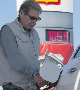  ?? CRYSTAL SCHICK/ CALGARY HERALD ?? Sam Smith fuels up at a pre-pay only pump after gas prices took a jump in Calgary on Thursday. Still, Statistics Canada reported year-over-year gas prices were down 21 per cent in April.