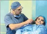  ?? AP ?? Dr Abbas alSahan makes surgical marks around the damaged ear of Saja Saleem, before her plastic surgery in Baghdad. She lost her eyesight, right arm and an ear in an explosion.