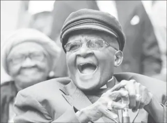  ?? ?? Archbishop Desmond Tutu laughs as crowds gather to celebrate his birthday by unveiling an arch in his honour outside St George’s Cathedral in Cape Town, South Africa, October 7, 2017. REUTERS/Mike Hutchings/File Photo Acquire Licensing Rights