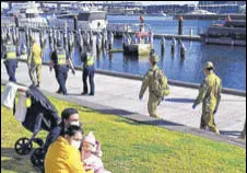  ?? AFP ?? Police and soldiers on patrol in Melbourne after the announceme­nt of restrictio­ns to curb Covid-19.