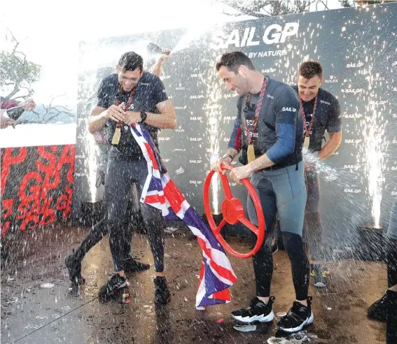  ??  ?? The British SailGP team, lead by skipper Ben Ainslie, centre, celebrate winning the first leg of the series in Sydney. Photo: AP