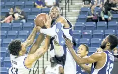  ?? BOB TYMCZYSZYN/POSTMEDIA NETWORK ?? The Niagara River Lions’ Josiah Moore and Halifax Hurricanes’ Antoine Mason battle for the ball in National Basketball League of Canada action Wednesday at Meridian Centre in St. Catharines.