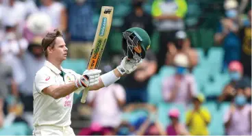  ??  ?? Australia’s Steven Smith acknowledg­es applause from the crowd after reaching his century against India during the third Test that ended on Monday