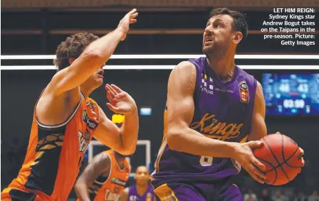  ??  ?? LET HIM REIGN: Sydney Kings star Andrew Bogut takes on the Taipans in the pre-season. Picture: Getty Images