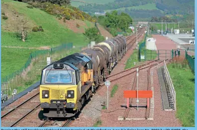  ?? ?? Passing the still trackless Highland Spring terminal at Blackford on June 2 is Colas loco No. 70813 with 6M86, the 14.05 Aberdeen Waterloo-Workington calcium carbonate train. The tanks on this occasion would be dropped off at Irvine and the loco would continue light to Workington.