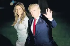  ?? Brendan Smialowski AFP/Getty Images ?? PRESIDENT TRUMP, with First Lady Melania Trump, returned to Twitter to attack the media over the widening inquiry into ties between his aides and Russia.