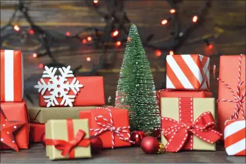 ?? COURTESY OF DREAMSTIME ?? Streamline your holiday gift wrapping and get a better look under the tree by using only a couple coordinate­d wrapping papers and unifying ribbon or yarn.