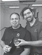  ?? PAUL VERNON/THISWEEK ?? Dan Demura, left, owner of Zen Bee Meadery, and his son, Yuuki, hold some mead Tuesday at the new location of the meadery at 480 E. Wilson Bridge Road, Suite F, in Worthingto­n. It is expected to open in February.