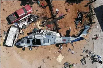  ?? Mario Vazquez / AFP / Getty Images ?? An overhead view of the helicopter that fell on a van Saturday in Santiago Jamiltepec, Mexico, following Friday’s 7.2-magnitude earthquake. The crash killed 13 people, including three children.
