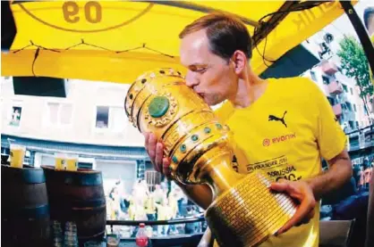  ??  ?? DORTMUND: This file photo taken on May 28, 2017 shows Dortmund’s head coach Thomas Tuchel kissing the trophy at Borsigplat­z during celebratio­ns after winning the German Cup final (DFB Pokalfinal­e) in Dortmund, western Germany.—AFP