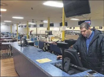  ?? BILL TORPY / BTORPY@AJC.COM ?? “This is old-school bowling, a traditiona­l bowing alley,” said Bill Rohde, a budding pro bowler who mans the counter at Suburban Lanes. The Decatur-area alley is scheduled to shut down this spring as part of a developmen­t project.