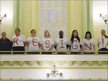  ?? Photograph­s by Rich Pedroncell­i Associated Press ?? PROTESTERS at the Assembly Gallery in May call on Assemblywo­man Cristina Garcia to step down.