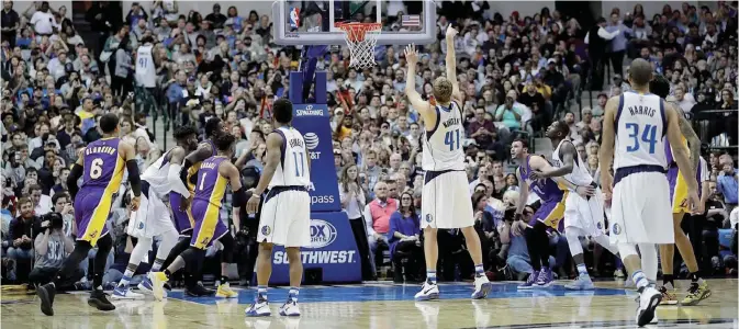  ??  ?? DALLAS: Dirk Nowitzki #41 of the Dallas Mavericks makes a free throw shot against the Los Angeles Lakers at American Airlines Center on Tuesday in Dallas, Texas. — AFP