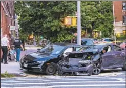  ??  ?? Smashed-up Honda Civics on street after perp allegedly drove one wrong way, forcing cars over curb where they crashed into a stroller, killing a baby and injuring the mom and two others. Suspect ran but was caught by cops.