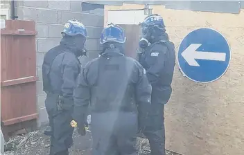  ??  ?? Police wore protective equipment during the raids