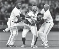  ?? FRANK GUNN, THE CANADIAN PRESS ?? Blue Jays hero Richard Urena, centre, is mobbed by teammates in the ninth.