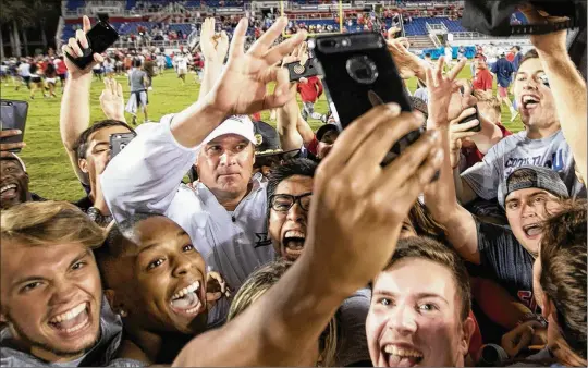  ?? ALLEN EYESTONE / THE PALM BEACH POST ?? Coach Lane Kiffin celebrates with fans after Florida Atlantic won the Shula Bowl against Florida Internatio­nal 52-24 at FAU Stadium in Boca Raton last November. Kiffin isn’t sure how long he’ll be at FAU, but he’s having fun so far.