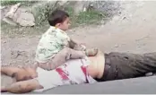  ??  ?? Three-year-old Ayaad sits on the chest of his slain grandfathe­r Bashir Ahmed Khan.