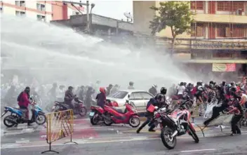  ??  ?? Police using a water cannon on protesters in Bangkok yesterday. – AFPPIX