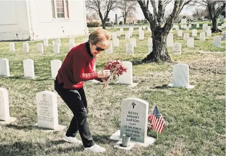  ?? MASON TRINCA FOR THE NEW YORK TIMES ?? “I think he was struggling,” Laura Larson said of her son. At his grave in Yakima, Washington.