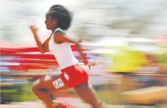  ??  ?? Denver East sophomore Arria Minor is a blur Sunday as she competes in the Class 5A girls 400 meters at Jeffco Stadium in Lakewood. Minor won the race with a time of 53.30 seconds. She also won the 100 and 200 over the weekend, giving her back-to-back...