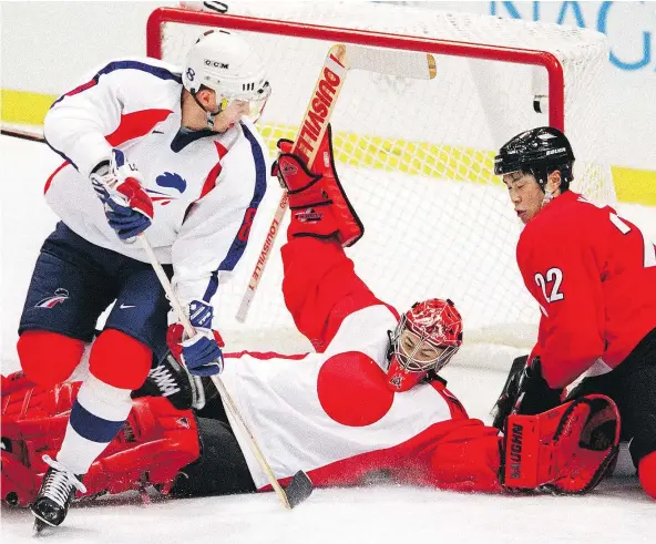  ?? — PHOTOS: GETTY FILES ?? Dusty Imoo, above, currently the goalie developmen­t coach for the L.A. Kings, played profession­ally in Japan and even represente­d the country at the 1998 Olympics in Nagano. On Saturday he backed up his son Jonah as a member of the Ontario Reign.