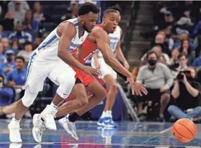  ?? CHRISTINE TANNOUS / THE COMMERCIAL APPEAL ?? Memphis Tigers guard Alex Lomax (10) and Southern Methodist guard Zach Nutall (10) fight for control of the ball.