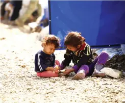  ??  ?? Displaced Iraqi children play at the Hammam Al-Alil camp, south of Mosul, on Tuesday. (Reuters)