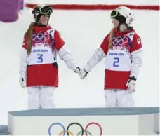  ?? RICHARD LAUTENS/TORONTO STAR FILE PHOTO ?? In one of the feel-good moments of the 2014 Winter Olympics, Canadian sisters Chloe, left, and Justine Dufour-LaPointe shared the moguls podium.