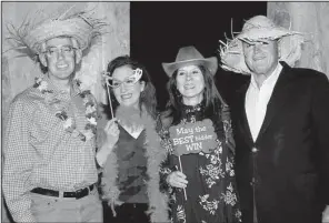  ??  ?? Raymond and Kimberly Molden with board member Melody and Judge Chris Piazza donning some props from the photo booth