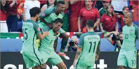  ??  ?? Cristiano Ronaldo (third left) and teammates celebratin­g Portugal’s qualificat­ion for the last-16 round of the Euro2016… yesterday